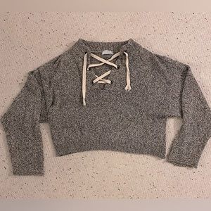 Gray Sweater with fashionable adjustable pull strings in the front. Size M